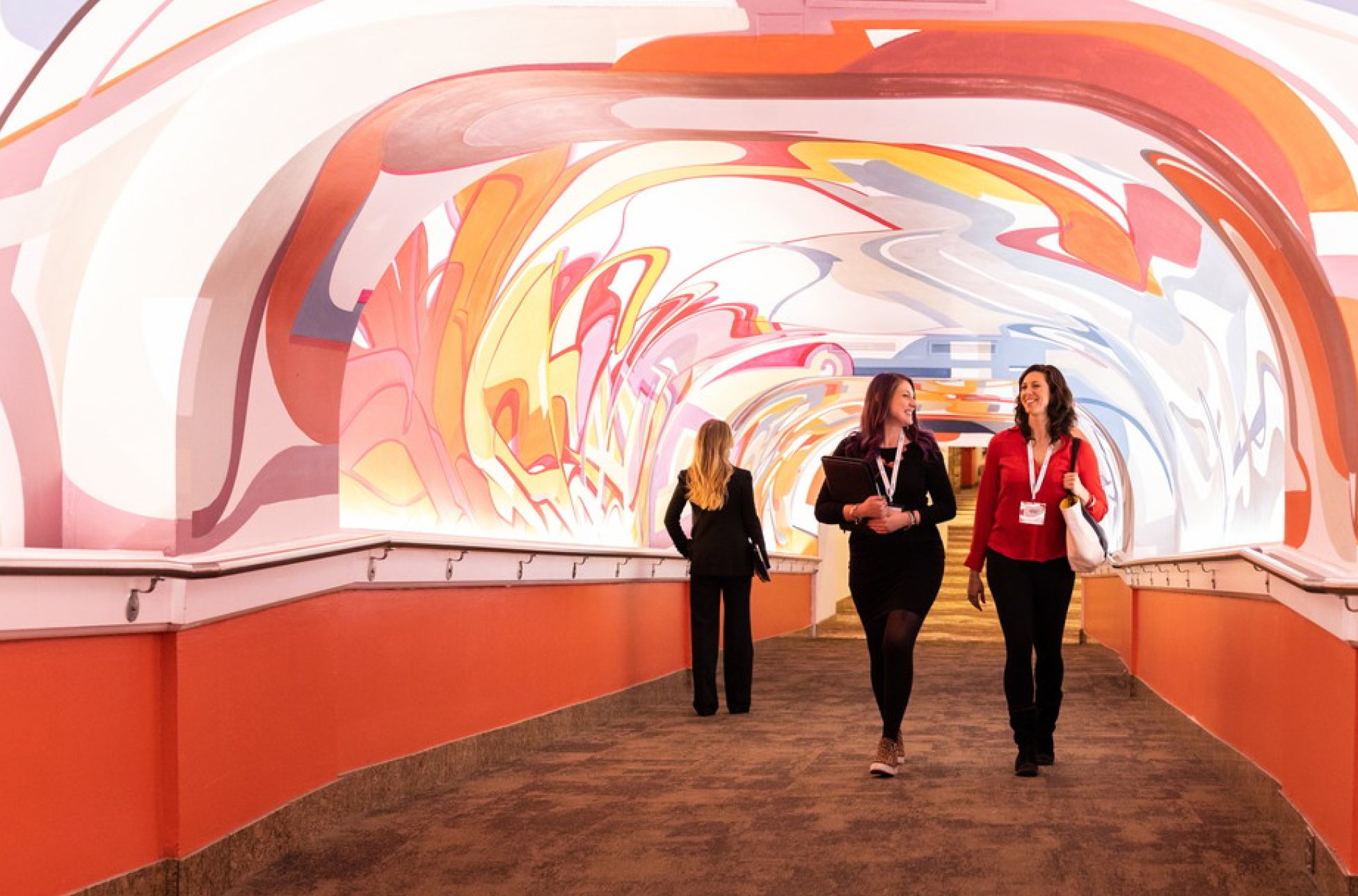 2 business professionals walking down a hallway